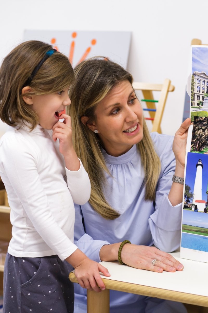 student and teacher looking at a poster